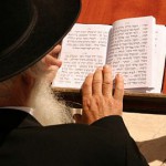 An Orthodox Jewish man reads from the siddur (prayer book) at the Western (Wailing) Wall