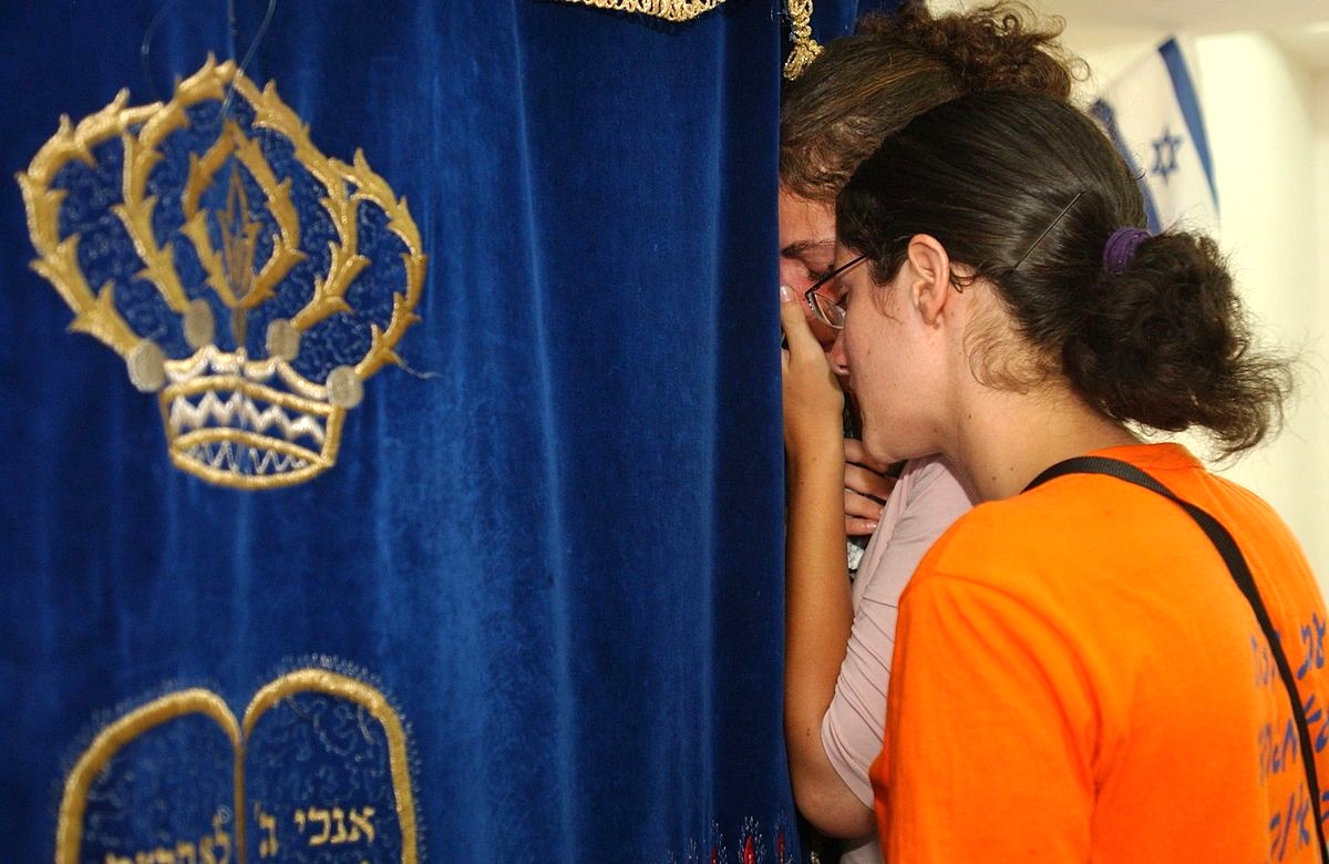 Residents of the Gush Katif community of Bedolach say a final prayer in their synagogue as security forces begin to evacuate the residents in the summer of 2005.