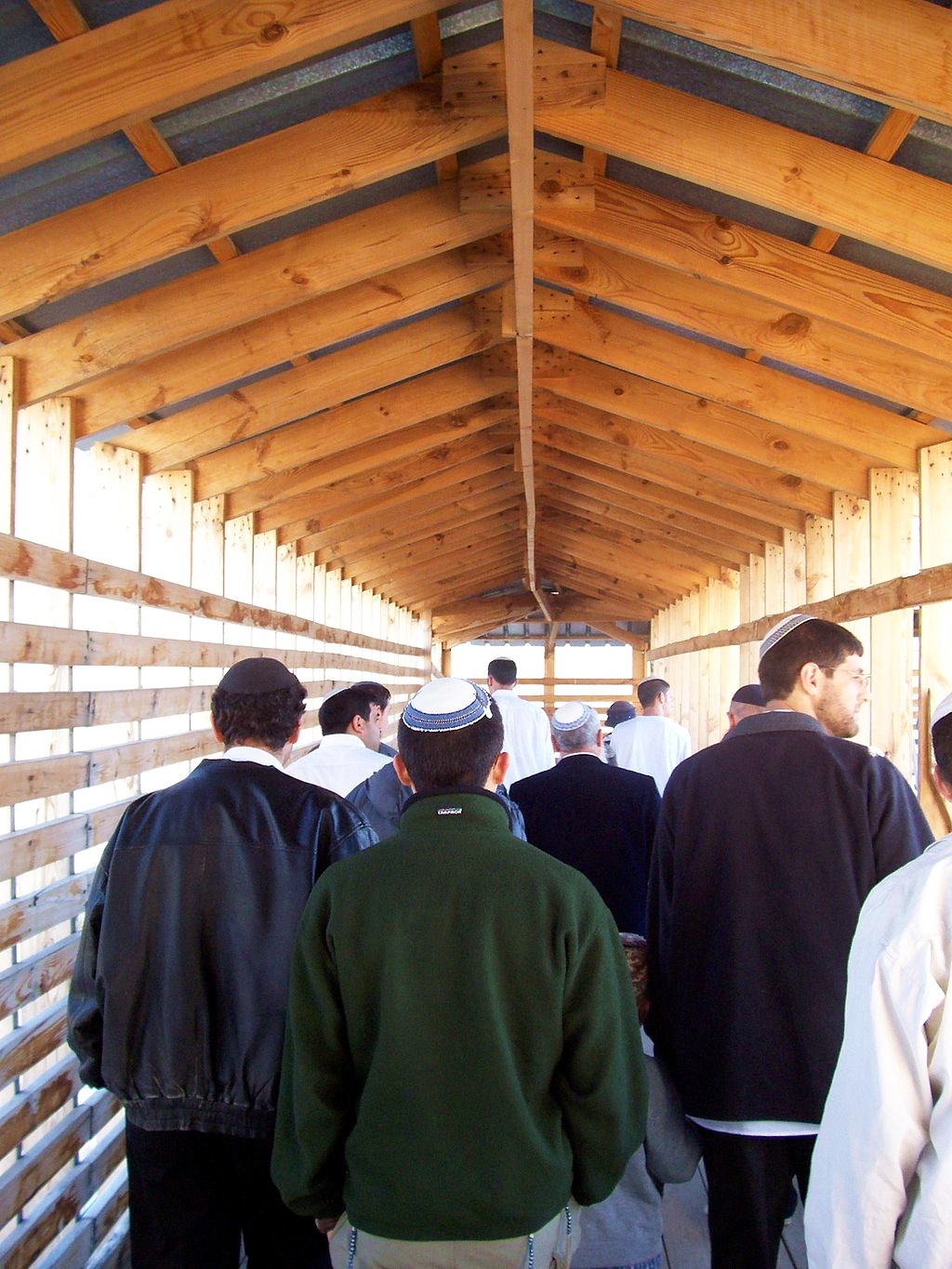 Jewish men enter the Temple Mount through the Mughrabi Gate