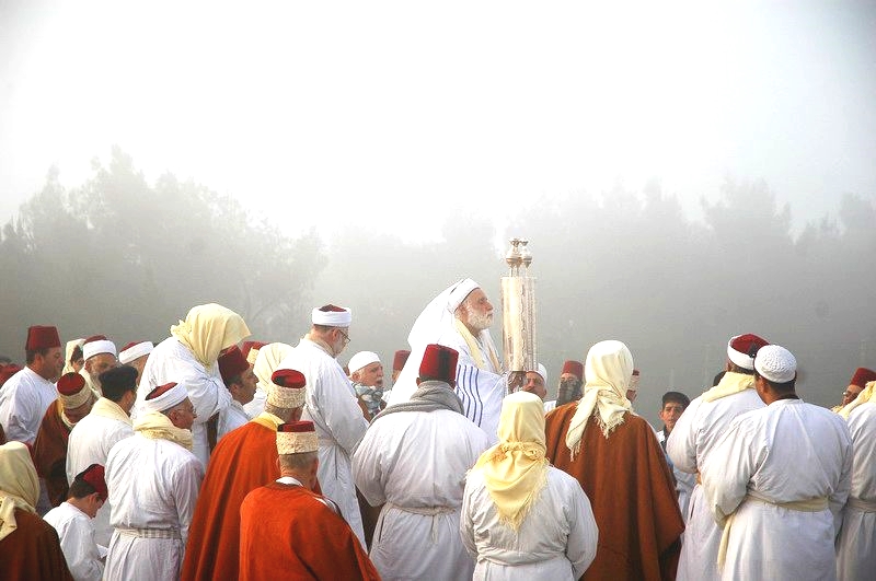 The Samaritans lift the Torah on Pesach (Passover) on Mount Gerizim.