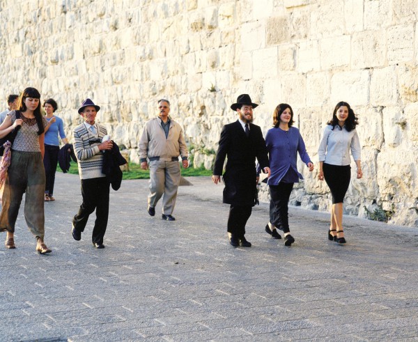 People walk along the walls of the Old City of Jerusalem. (Photo: Go Israel)