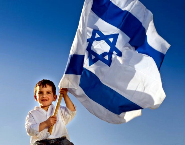 A Jewish lad holds the flag of the State of Israel.