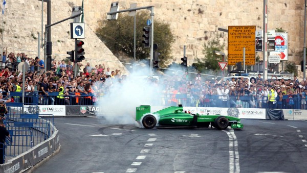 Formula 1 race cars speeding through the streets of Jerusalem thrill spectators.