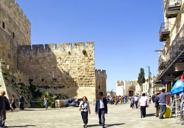 An Orthodox Israeli couple walks along the walls of Jerusalem.