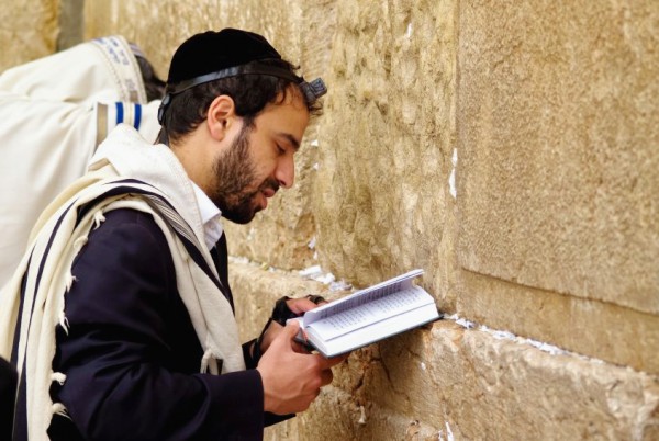 Jewish man-prays-Western Wailing Wall-tefillin-phylacteries-tallit-shawl