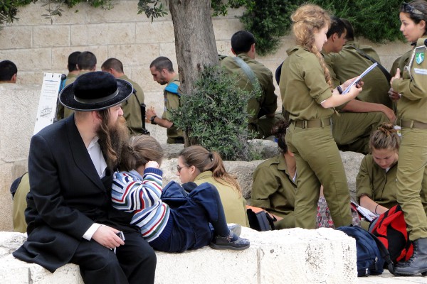 A father sits with his daughter in Jerusalem. Around the two are the young men and women who are called upon to protect Israel from the nation's enemies.