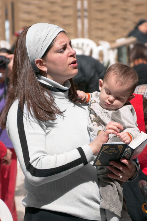 Jewish woman prays at the Kotel (Wailing Wall)