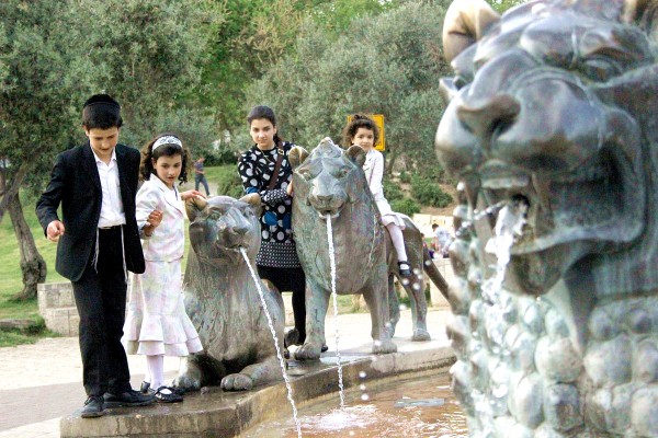 Orthodox siblings play at the Lions Fountain in Jerusalem