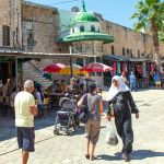 People of many ethnicities on a street in Acre, Israel