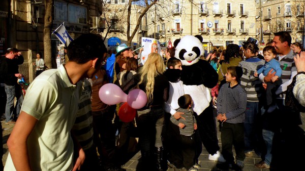 Purim is a joyous festival of costumes, parades and parties.  In the above   photo, Israelis celebrate Purim in the streets in Jerusalem.  (Photo by   Ron Almog)