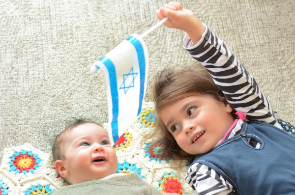 Young Israeli entertains her sibling.