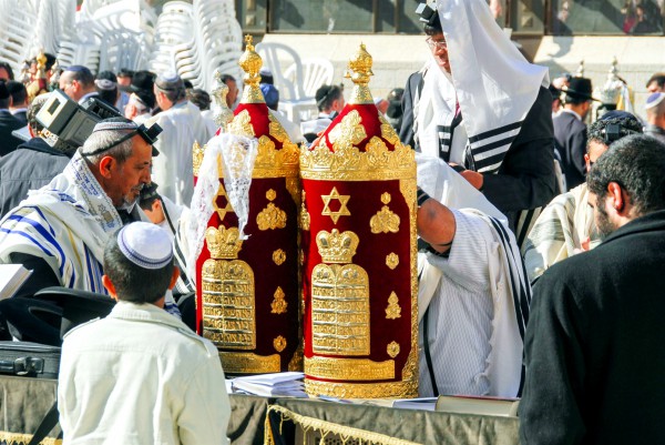 A 13-year-old Jewish boy stands before the Torah scroll during his Bar Mitzvah at the Western (Wailing) Wall in Jerusalem.