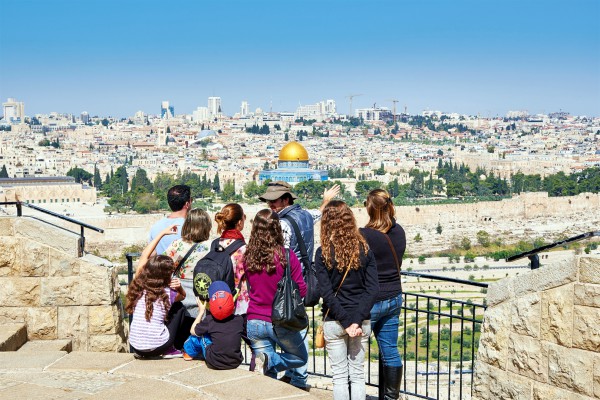 Tourists on the Mount of Olives look toward the Temple Mount where the First and Second Jewish Temples once stood. Currently the Muslim Dome of the Rock stands on the spot where they were located.