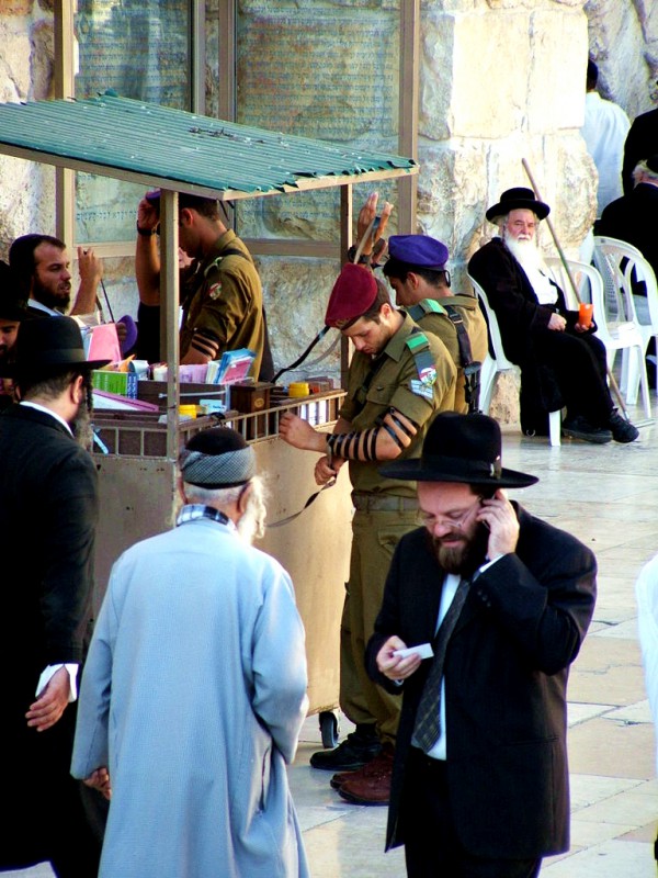 Israeli soldiers wrap tefillin (phylacteries) at the Western (Wailing) Wall for morning prayer.