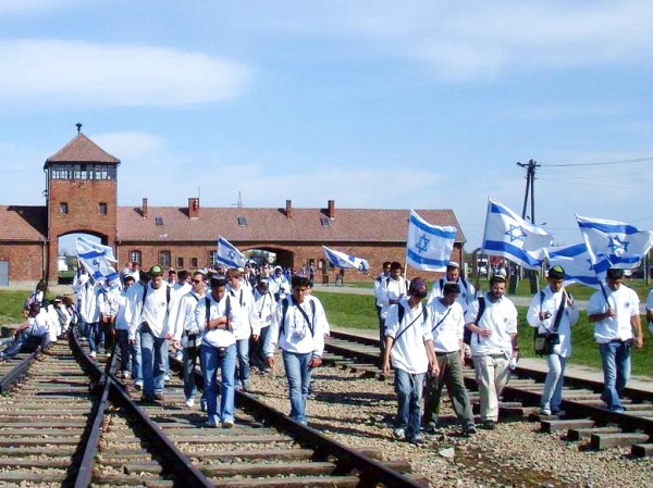 Young people raise the Israeli flag high during the March of the Living at Auschwitz.