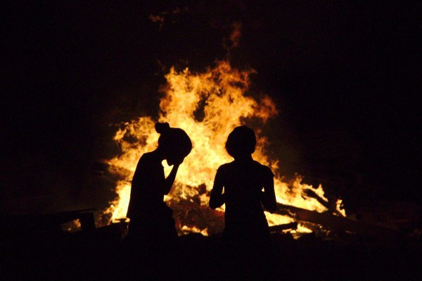 Israeli girls admire the traditional Lag BaOmer bonfire. (Photo by Ari B.)