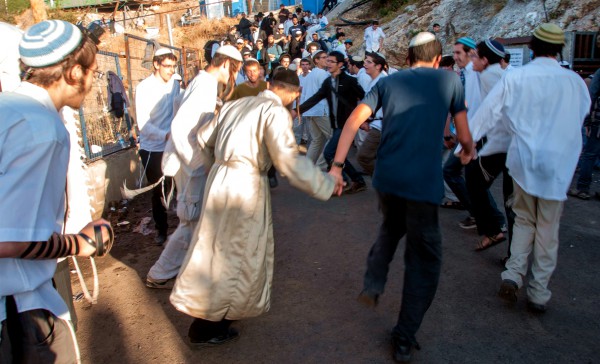 Orthodox Jewish men dance and rejoice on Lag BaOmer in Meron, the location of the tomb of Mishnaic-era sage Rabbi Shimon bar Yochai. Tens of thousands of visitors are drawn here during Lag BaOmer to pray and celebrate. Many camp out for days.