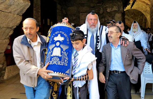 Jewish father and son, Western (Wailing) Wall, Jerusalem, carrying Torah scroll