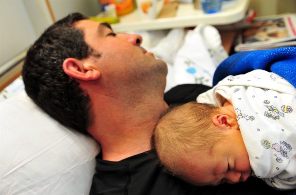 A newborn naps on his father's chest in an Israeli hospital.