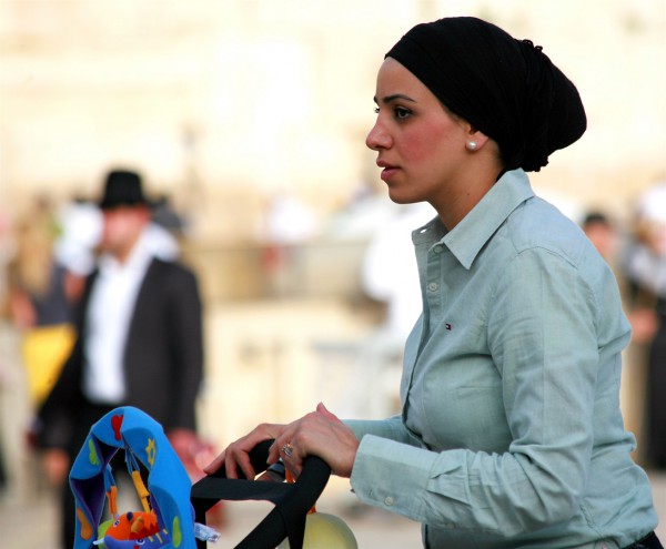 Jewish mother pushes a stroller in Jerusalem. (Photo by opalpeterliu)