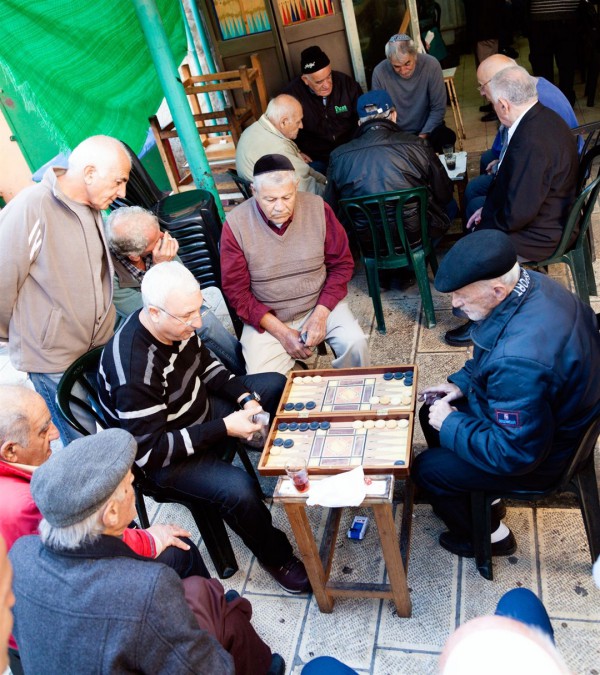 Jewish men play backgammon in Jerusalem's Mahane Yehuda Market.