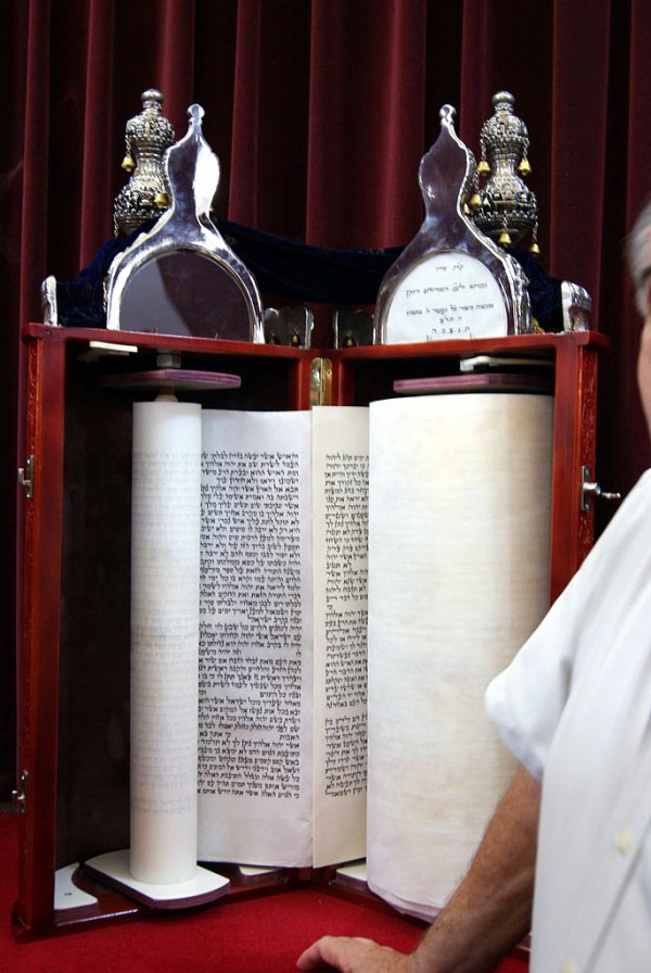 Reading from a Torah scroll encased in a protective Torah tik.