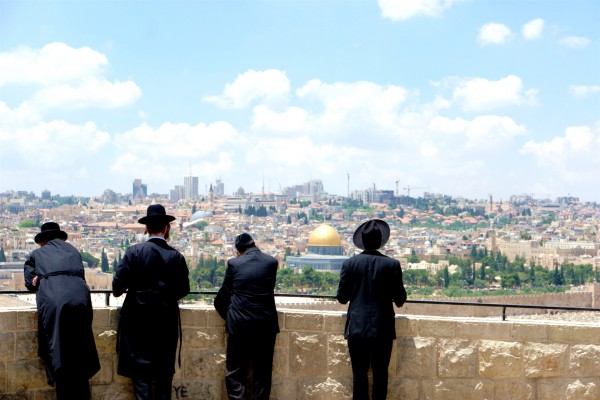 Orthodox Jewish men look toward Jerusalem and the Temple Mount from the Mount of Olives.