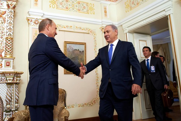 Israeli Prime Minister Benjamin Netanyahu (left) shakes hands with Russian President Vladimir Putin  at the Novo-Ogaryovo state residence outside Moscow, Russia, September 21. 