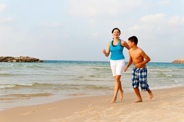 A Jewish mother and son have fun together on a beach in Israel.