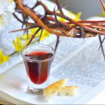 crown of thorns, wine glass, Bible, and flowers