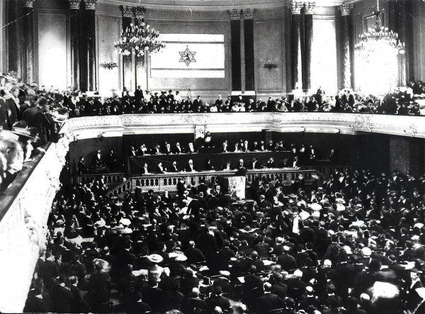 The flag above that hung on the World Zionist Congress wall (1897 or 1898) was partly designed from the vision of the movement’s first president, Theodor Herzl. This design, however, was not approved by the Zionist Congress.